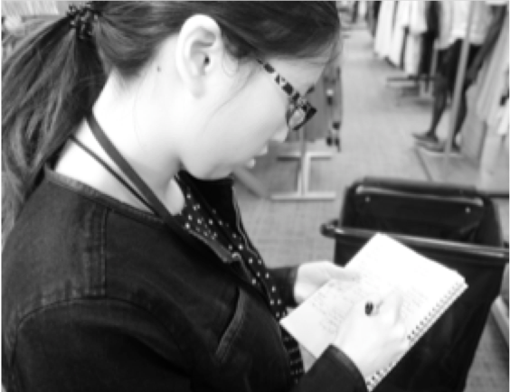 Taking notes during an in-store observation.